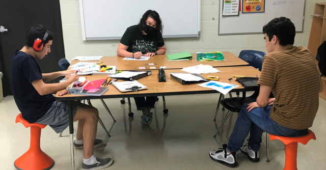 Students using Hokki stools.