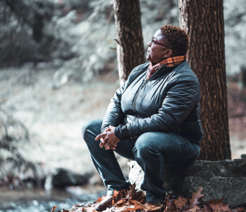 Woman in nature practicing self-care