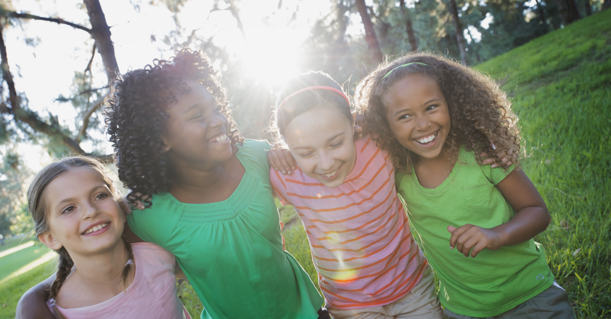 Four little girls participating in outdoor acitivites