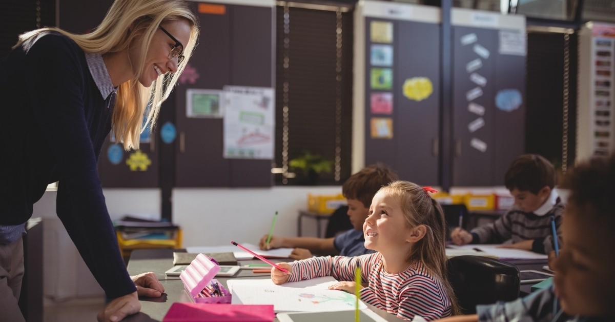 Teacher talking to student in the classroom