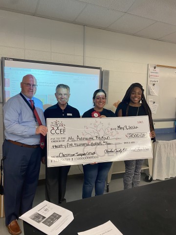 Adrienne Fagan of Woodstock Highschool at the front of the classroom receiving her 2022 Impact Grant.