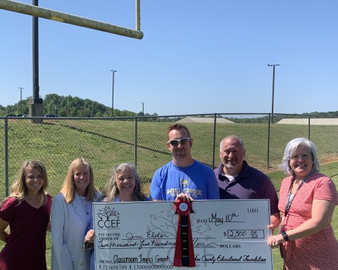 Jim Elder of Mill Creek Middle standing outside receiving his 2022 Impact Grant