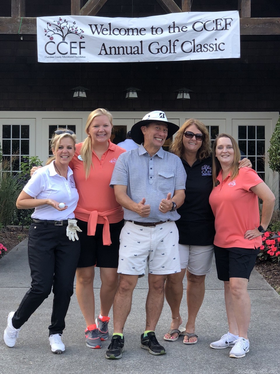 Smiling golfers under CCEF banner