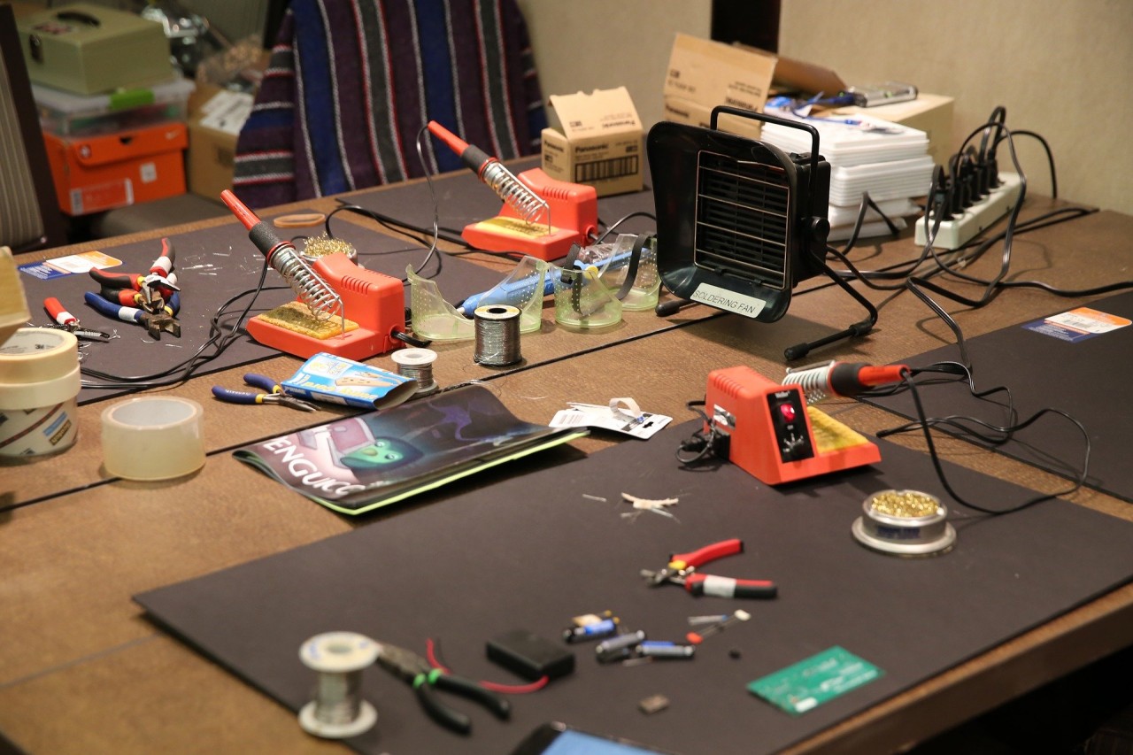 Work space table with various tools scattered.